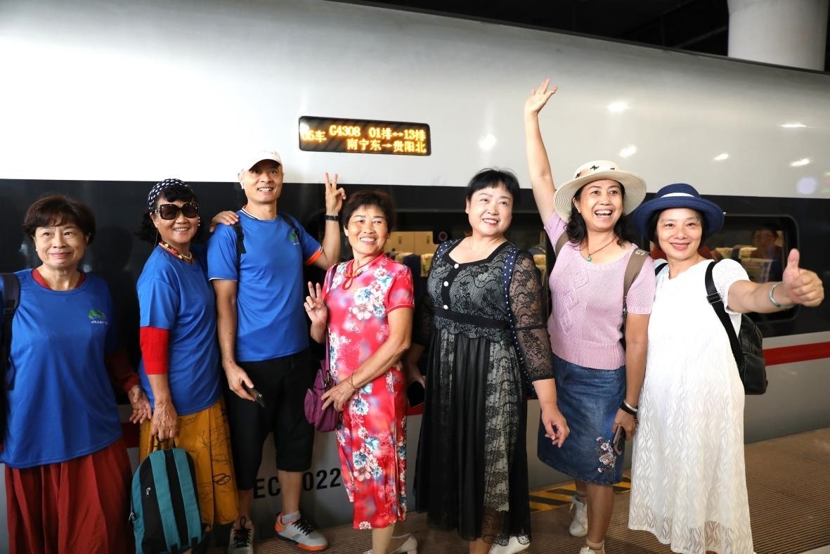 在南寧東站，旅客與貴南高鐵首發(fā)列車合影。 林祥云攝