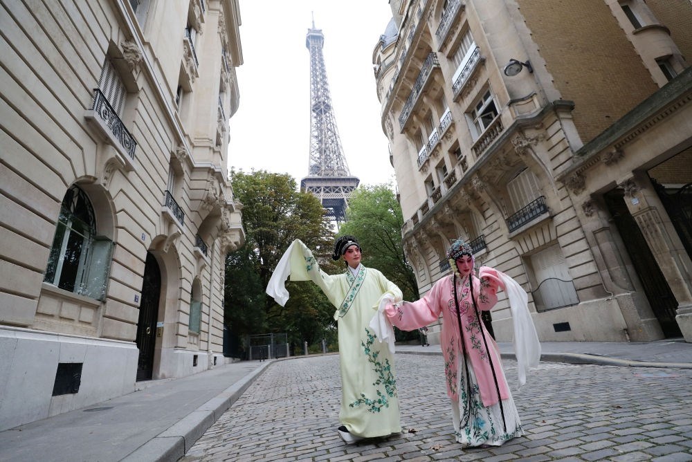 2023年9月13日，江蘇省演藝集團昆劇院院長施夏明（左）和江蘇省演藝集團昆劇院國家一級演員孔愛萍在法國巴黎埃菲爾鐵塔附近參加昆曲快閃。新華社記者 高靜 攝