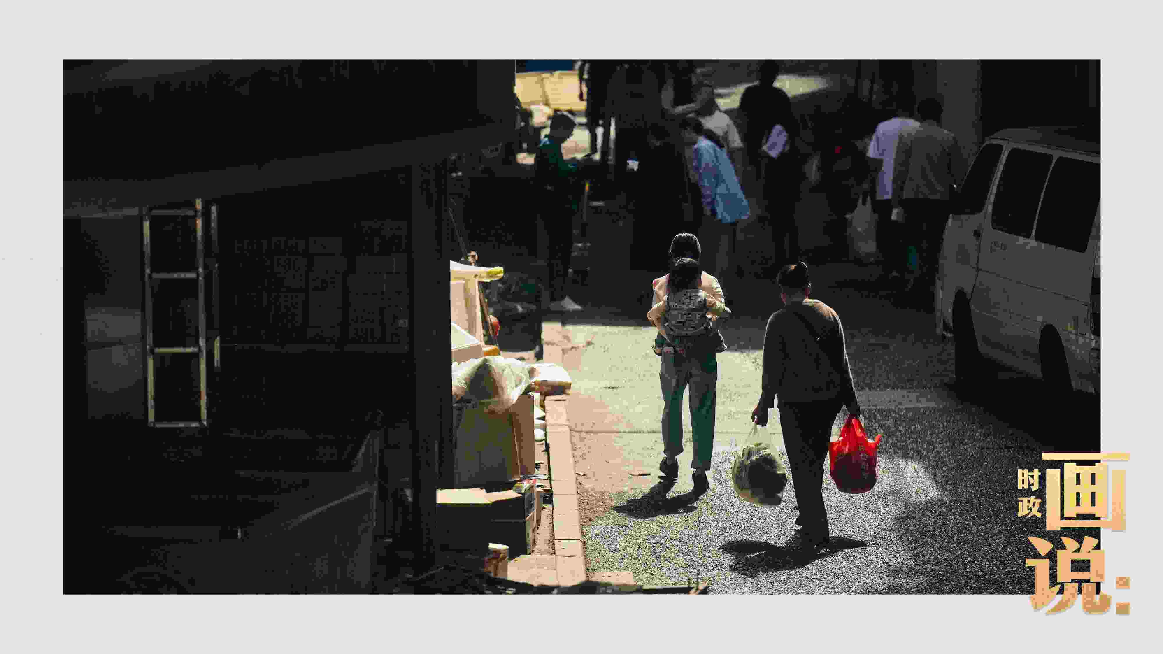 △老城區(qū)鱗次的樓宇間漏下一縷光，路人走過(guò)暖陽(yáng)。