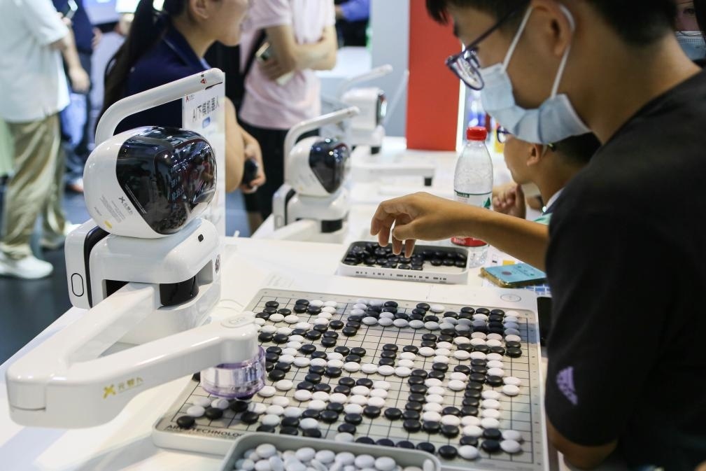 2023年7月7日，元蘿卜AI下棋機器人與觀眾對弈。2023年7月6日至8日，2023世界人工智能大會在上海舉行。新華社記者 辛夢晨 攝